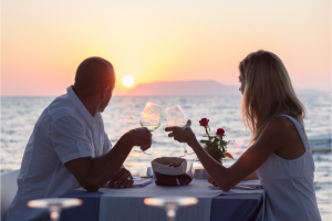 Romantic couple having a dinner with sunset view